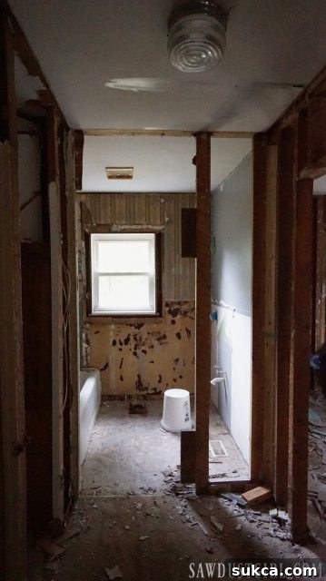 Calderwood Cottage Demo Days! Close-up of wall removal showing exposed studs and wiring.