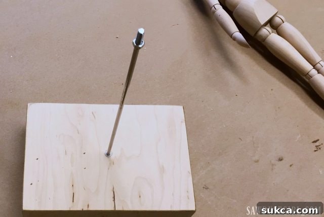Attaching Mannequin to Lamp Securing Mannequin Bolt to Base