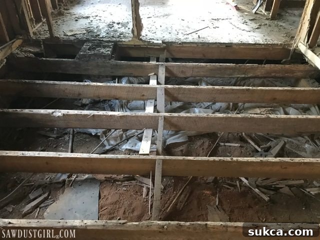 Full kitchen subfloor removal and preparation for floor joist replacement at Calderwood Cottage