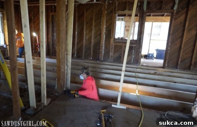 Supporting the floor with jacks for structural repairs Jacking up the floor during Calderwood Cottage renovation