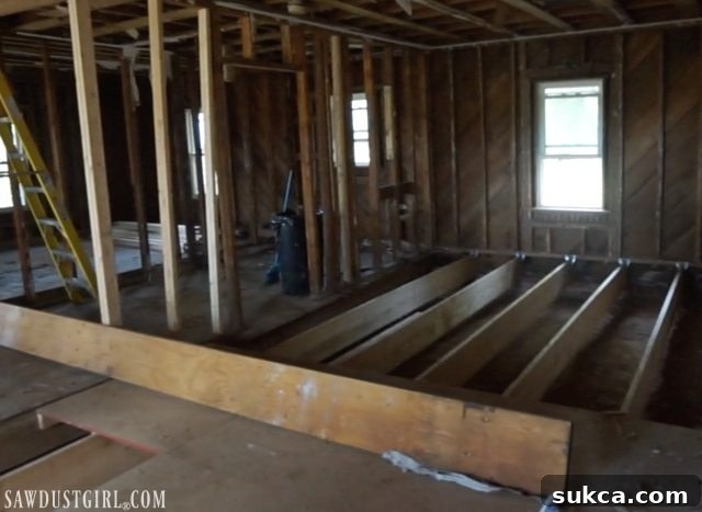 Lam beam ready for installation to create vaulted ceilings Installing an engineered beam for ceiling support in Calderwood Cottage
