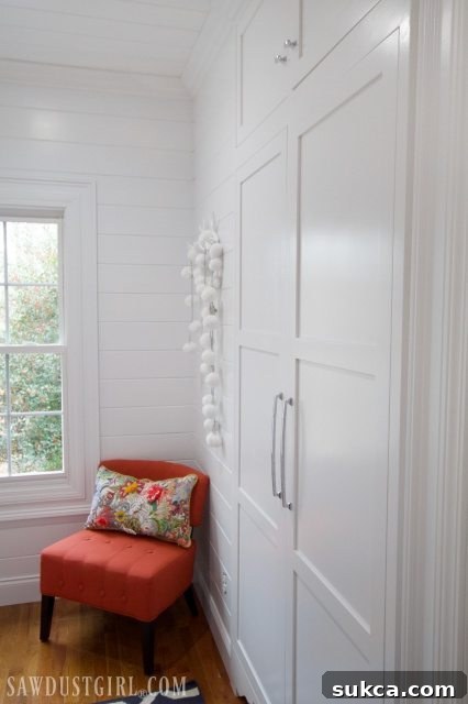 Detailed shot of guest room decor, including a decorated bed and wall art.