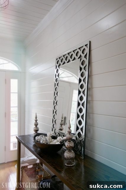 Entryway decor with a mirror and holiday embellishments, leading into the main living space.
