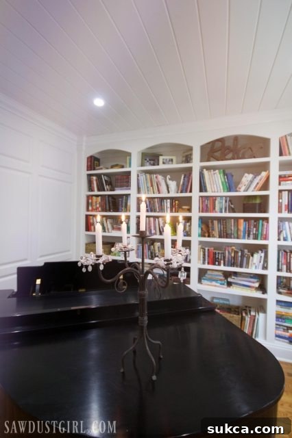 View of a spacious, decluttered library with a large window, inviting readers in.