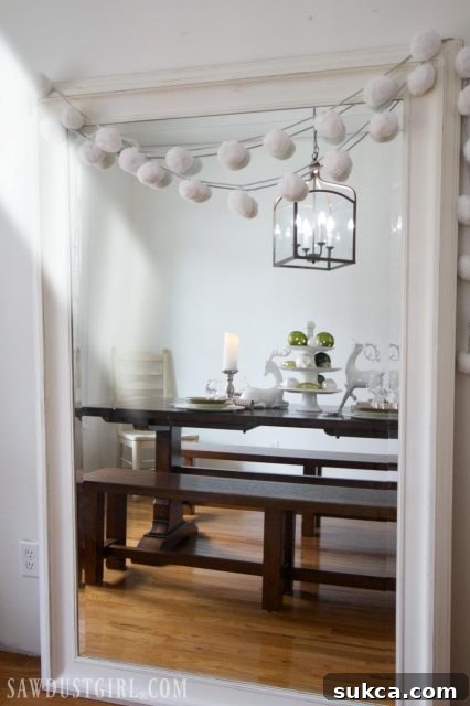 Large white mirror reflecting the decorated dining room, adding depth to the space.