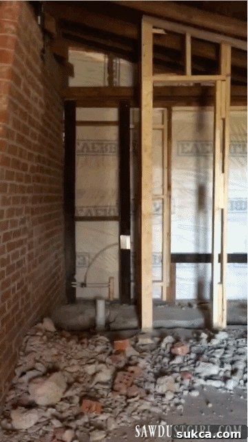 Precision Work on the Brick Wall Calderwood Cottage cutting brick wall