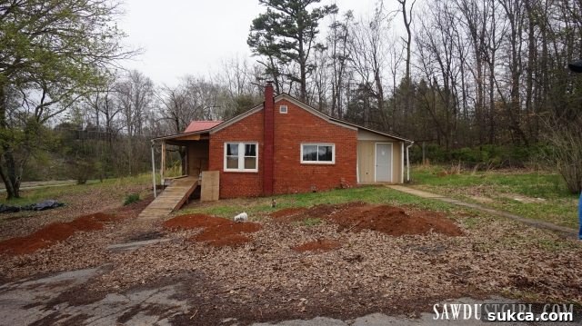 A wide shot of Calderwood Cottage, with the entire exterior renovation area now completely cleared, tidy, and perfectly prepared for the upcoming new construction phase.