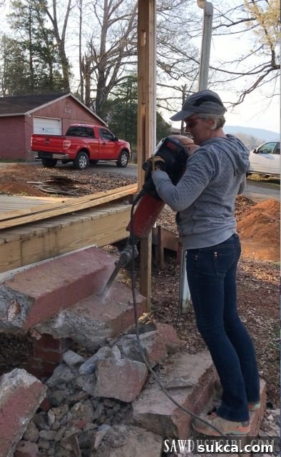 A person actively operating the 80-pound jackhammer, showcasing the physical intensity and protective gear required for concrete demolition.