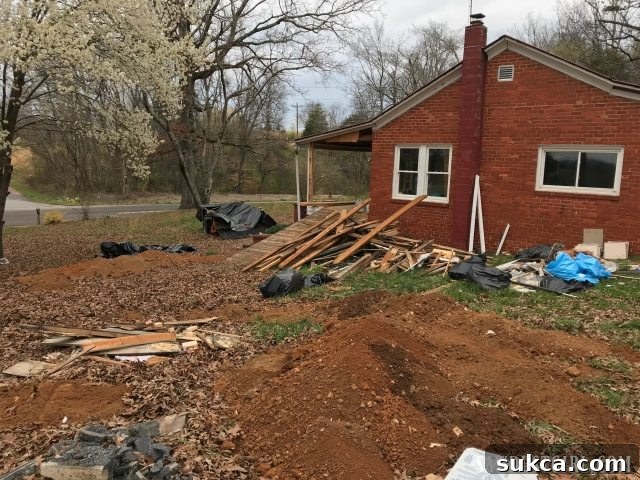 An expansive view of Calderwood Cottage's yard on clean-up day, showcasing the scattered demolition debris awaiting collection and removal into the dumpster.