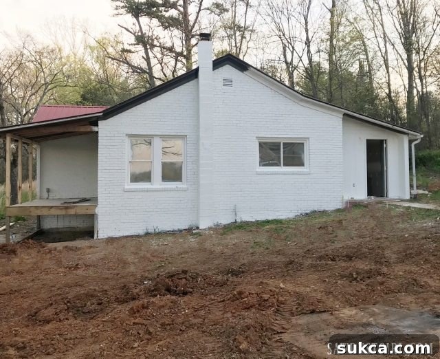 White painted brick house with contrasting trim