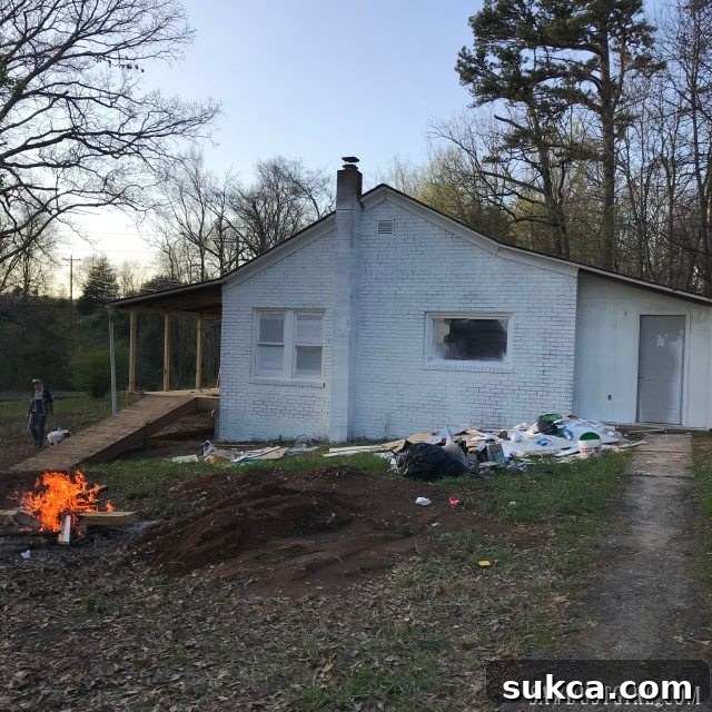 Exterior house after one coat of masonry paint