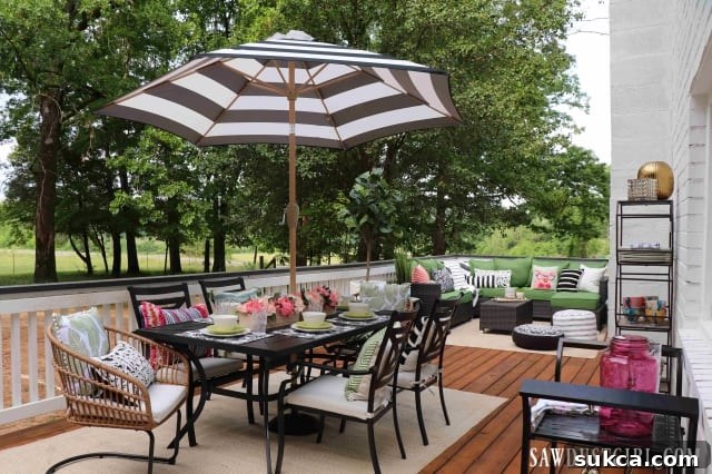 Furnished wood deck at Calderwood Cottage, showing comfortable seating and dining areas.