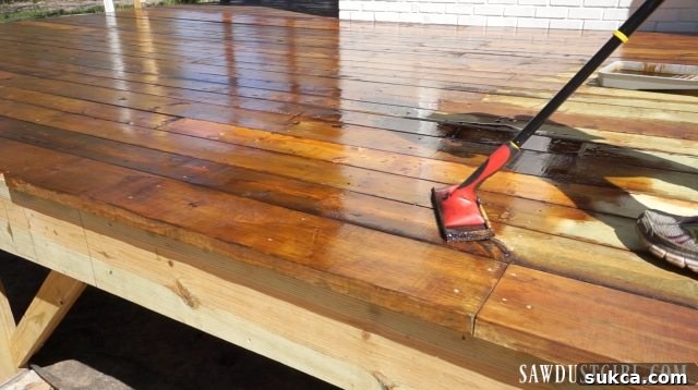 The newly installed deck surface, beautifully stained and sealed, reflecting the final stages of completion.