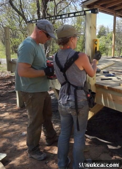 Installing sturdy posts for the deck railing system, a critical safety and design element.