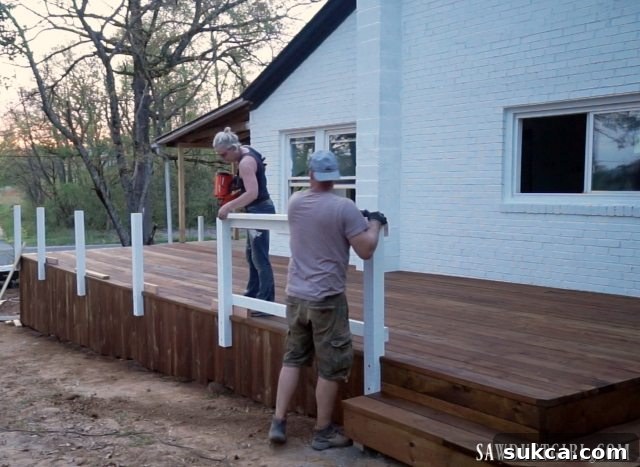 The process of installing the main deck railings, defining the outdoor living space.