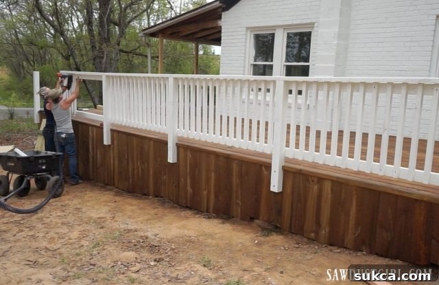 The meticulous installation of deck spindles, adding intricate detail to the railing.