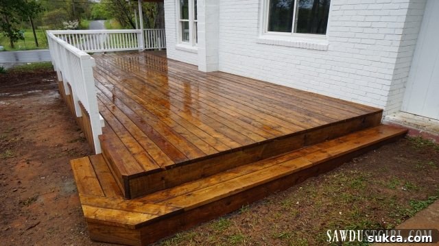 Wider shot of the newly built deck at Calderwood Cottage, highlighting its size and integration.