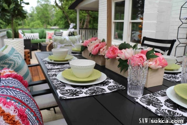 Another perspective of the furnished wood deck, featuring a comfortable sectional and ample seating.