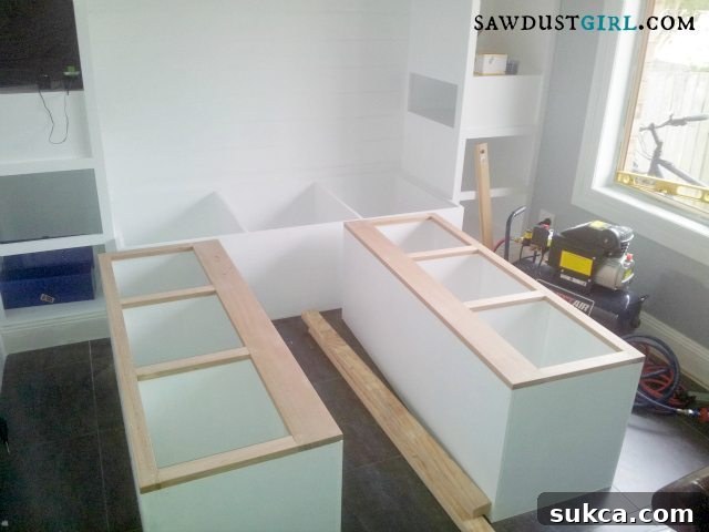 Two sides of the custom built-in bed frame for bedroom storage taking shape, demonstrating major project progress - SawdustGirl.com