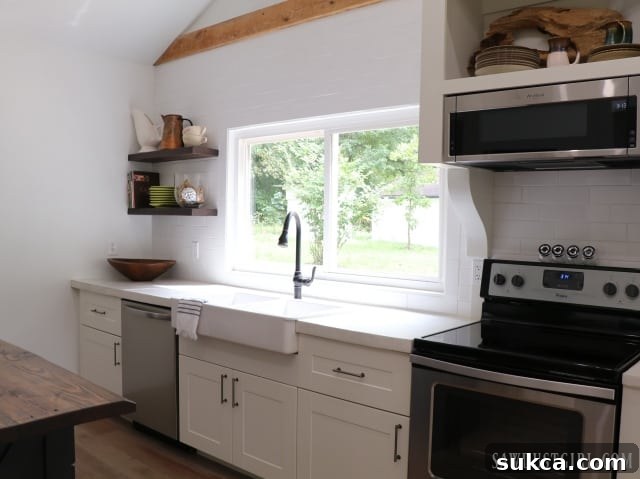 Kitchen detail with classic white subway tile backsplash and rustic floating wood shelves