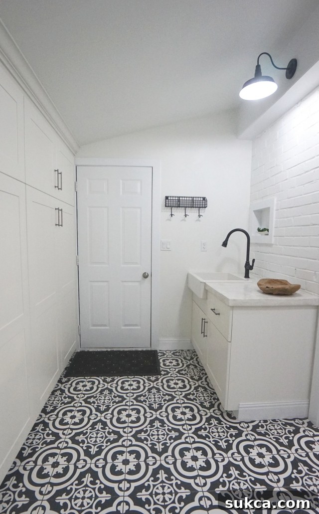 Functional and stylish laundry room/mudroom with concrete countertops and farmhouse sink