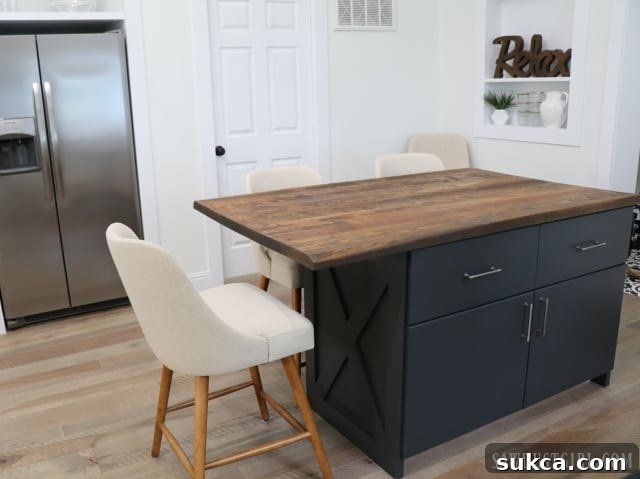 Kitchen island detail, highlighting reclaimed wood top, leading towards master suite entrance