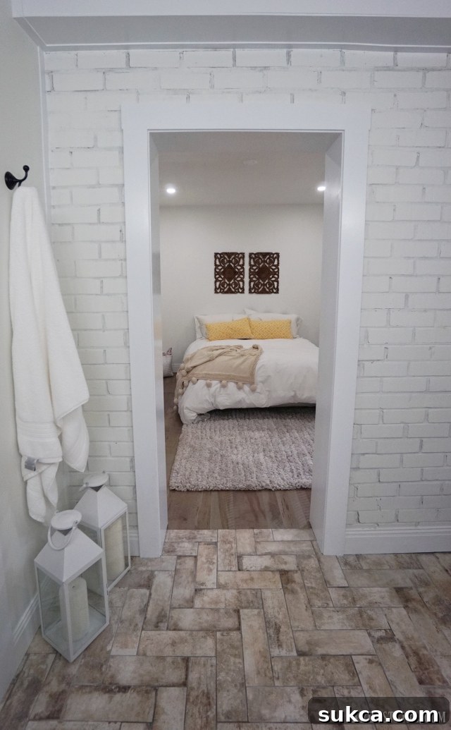 Master bedroom doorway revealing an exposed original brick wall in the master bathroom