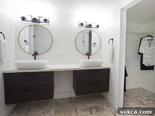 Modern master bathroom featuring double vanity and natural light