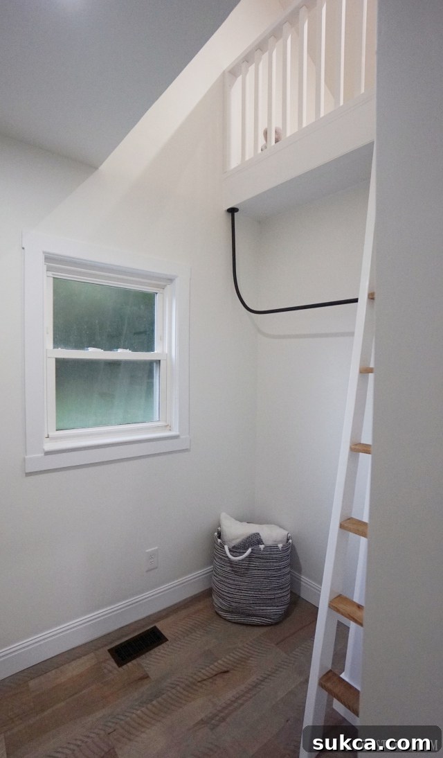 Bedroom featuring a cozy loft space accessible by a custom-built ladder