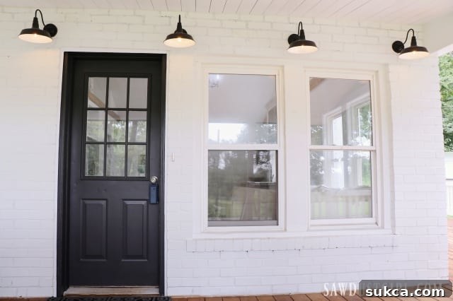 Inviting front porch with a striking black door, enhancing curb appeal