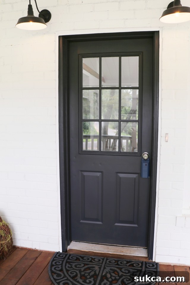 Elegant black front door with modern hardware, a focal point of the exterior