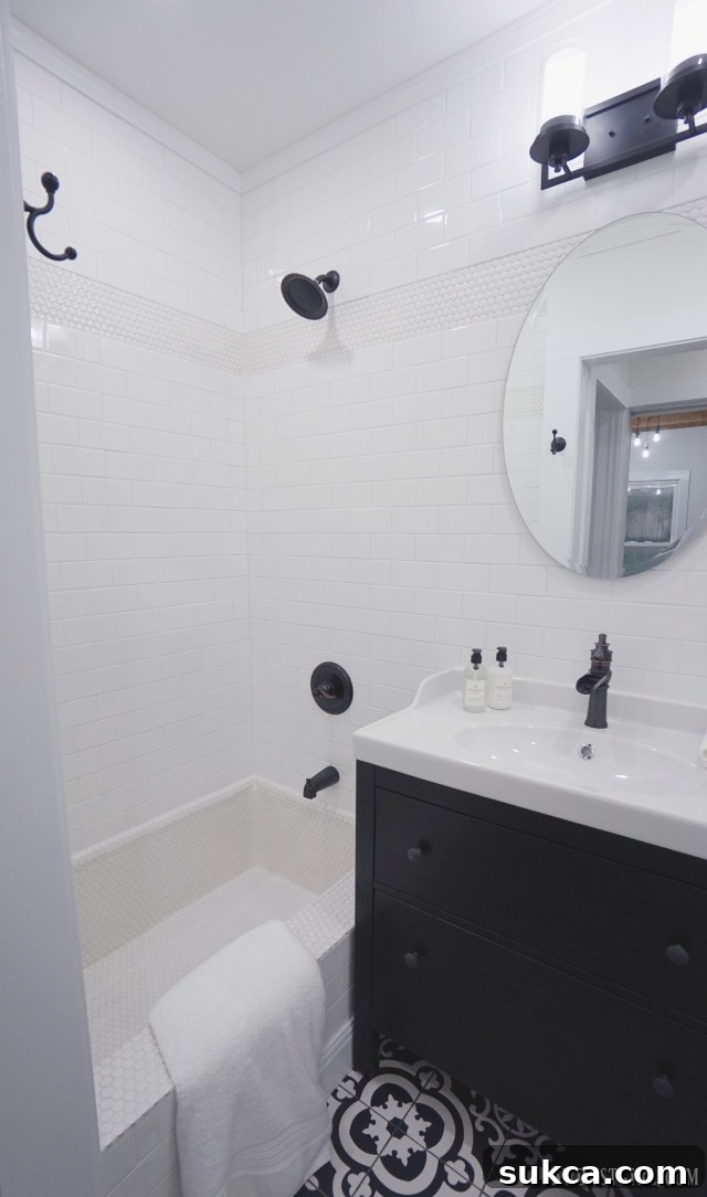 Elegant black and white guest bathroom with custom tile work