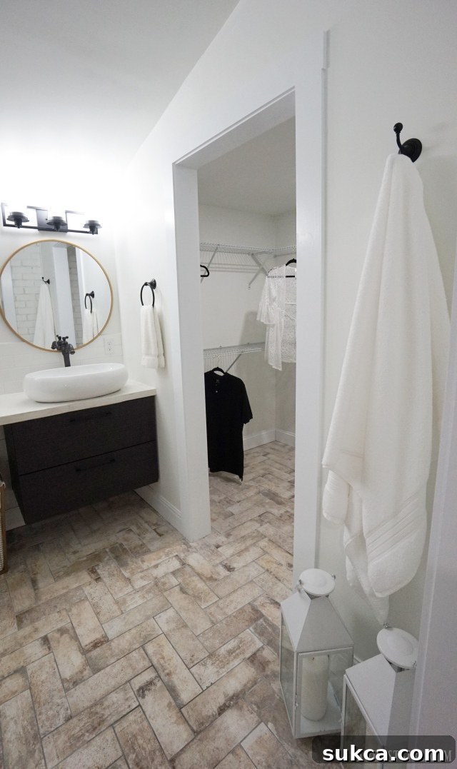Stylish herringbone tile bathroom floor, adding texture and sophistication to the space