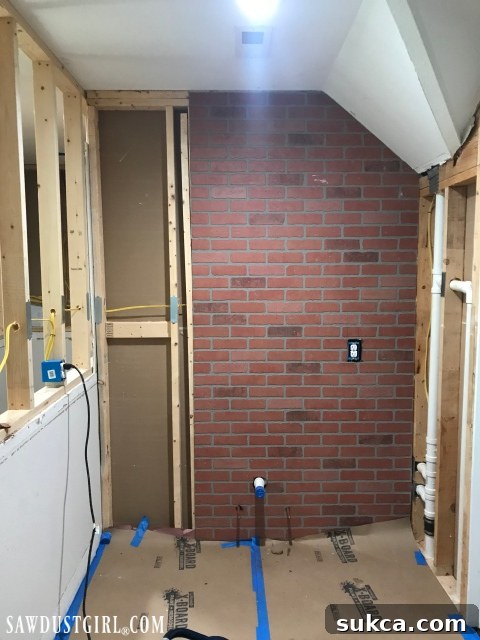 Making progress with faux brick in the loft Progress shot of brick paneling installation with a track saw in view