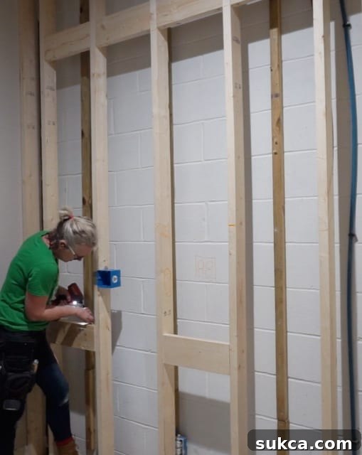 Framed wall with added wooden blocking for secure cabinet installation in a wet bar area