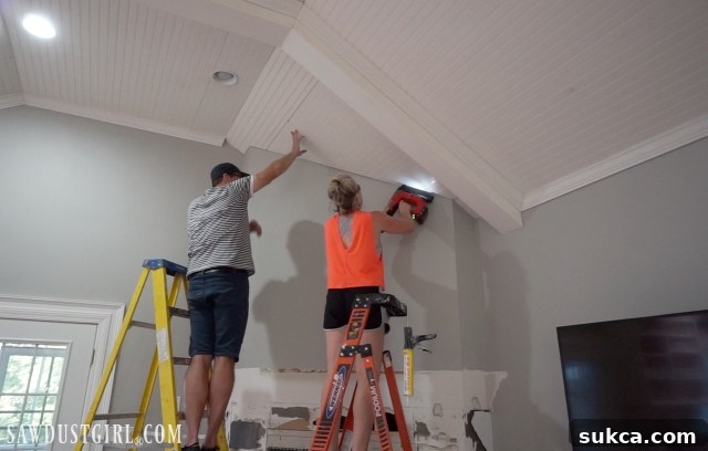 Wes helping with ceiling beadboard installation, a key step in living room renovation