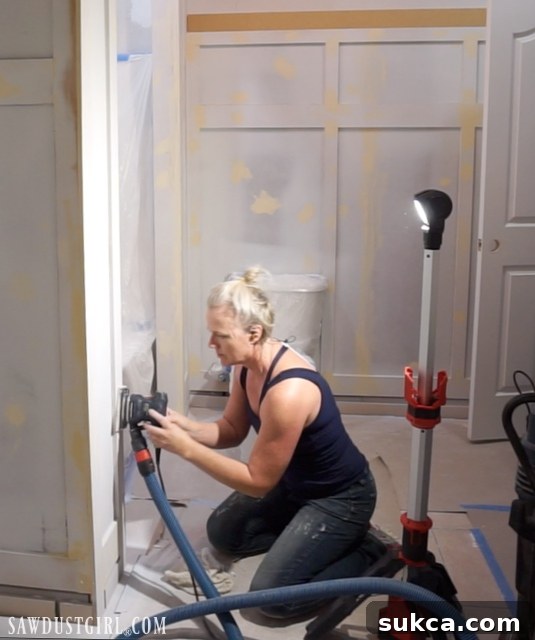 Power sanding the wainscoting to remove filler and imperfections
