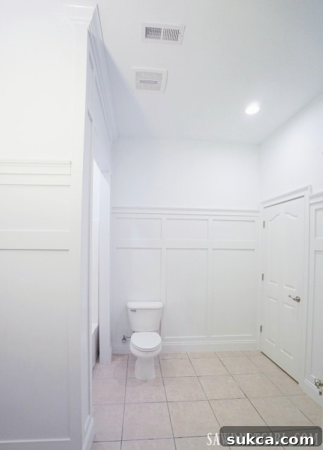 Finished all-white board and batten wainscoting in the bathroom