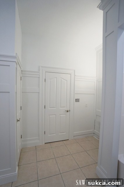 Close-up of the bathroom floor tile next to the newly installed wainscoting