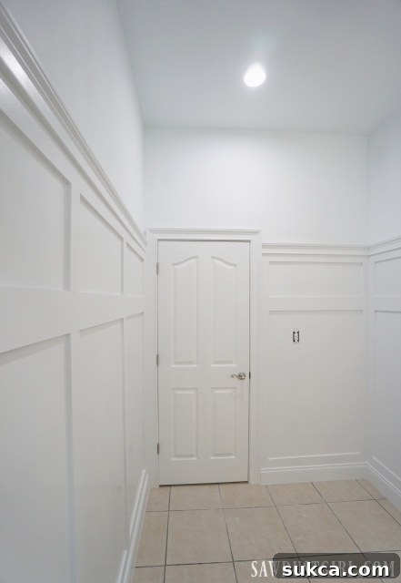 Perspective view of the renovated bathroom with wainscoting