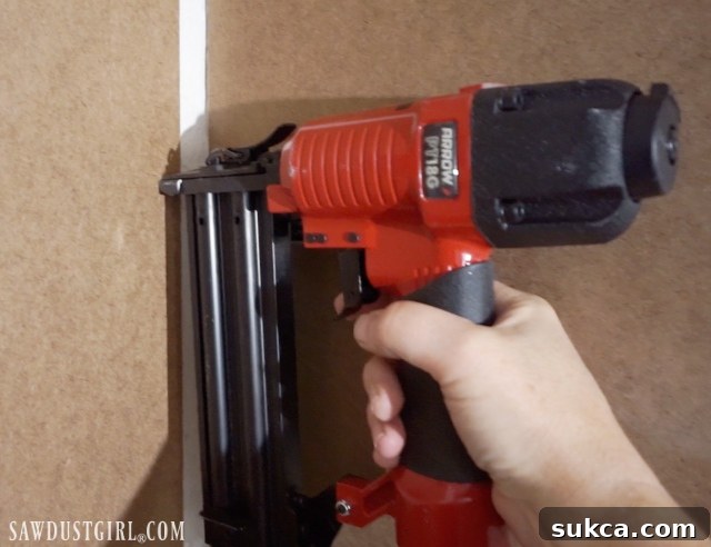 Securing hardboard panels with adhesive and nails