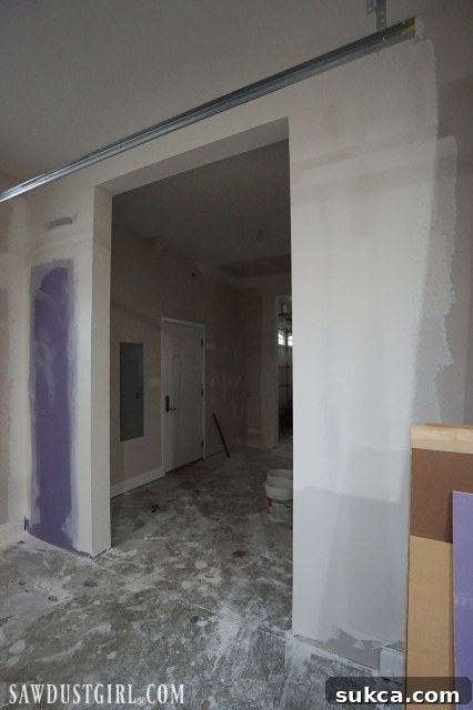 Drywall installed around new doorway framing in garage