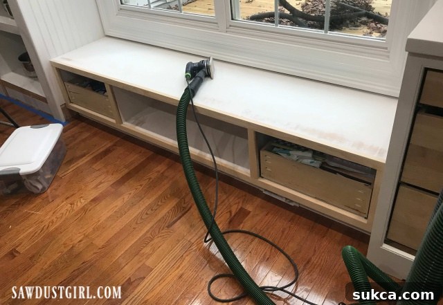 Built-in window seat with toe-kick vacuum port