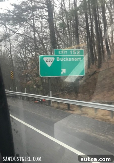 A humorous sign for 'Bucksnort, TN,' hinting at the playful search for a new town for Julie.