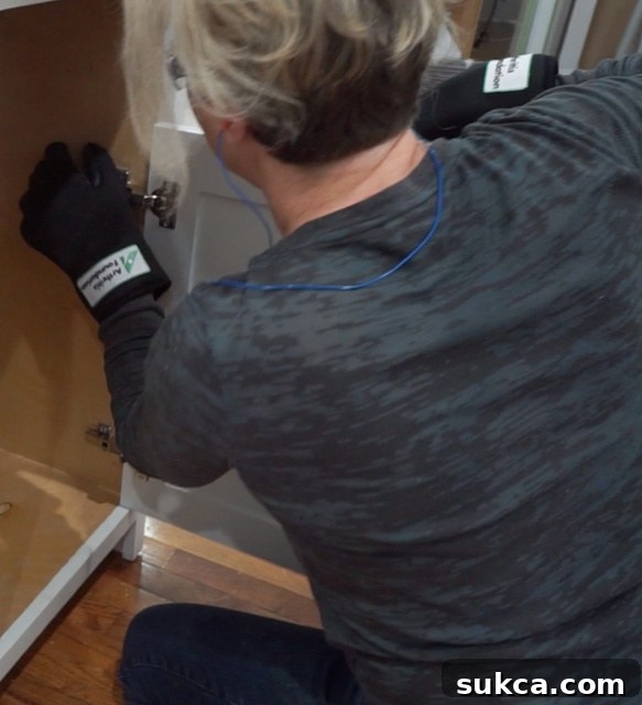 Woman using tools while wearing arthritis simulation gloves