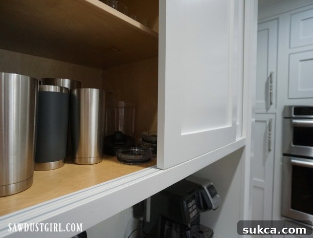 Clean and elegant sliding cabinet doors without pulls, showcasing a minimalist design aesthetic in a contemporary kitchen.