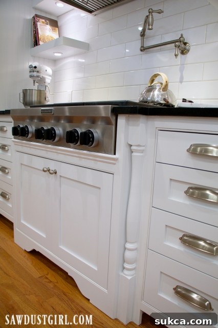 Cooktop cabinet with decorative legs, wide shot of kitchen highlighting the integrated design