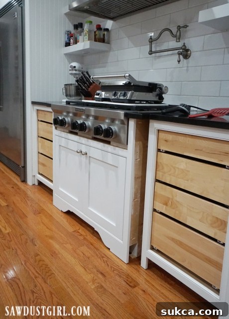 Finishing cooktop cabinet, highlighting the empty space awaiting decorative legs for a refined look