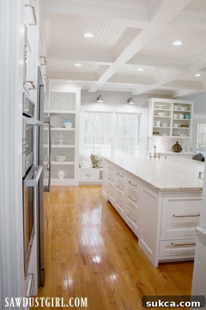 A well-organized kitchen with abundant storage space in white cabinets and a large island.