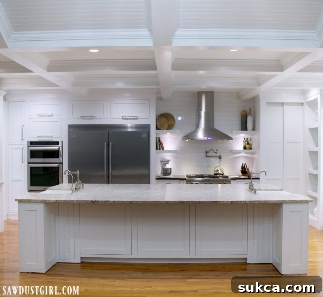 Clever hidden storage within the kitchen island, disguised behind panel-like doors.